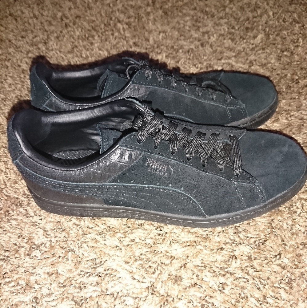 All black suede Pumas